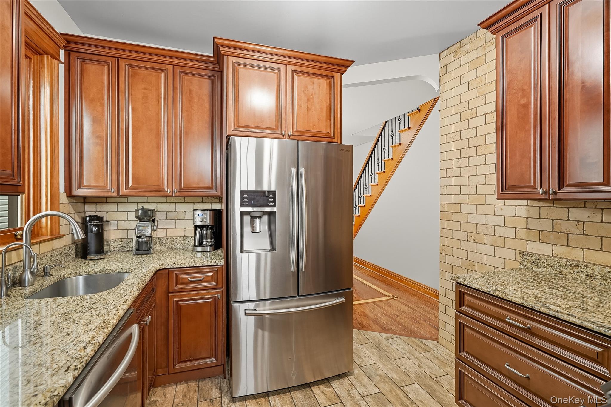 1444 Gillespie Avenue Bronx, NY 10461 - Photo 11 of 49 a kitchen with granite countertop a refrigerator and wooden cabinets