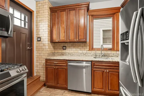 a kitchen with stainless steel appliances granite countertop a stove and a refrigerator