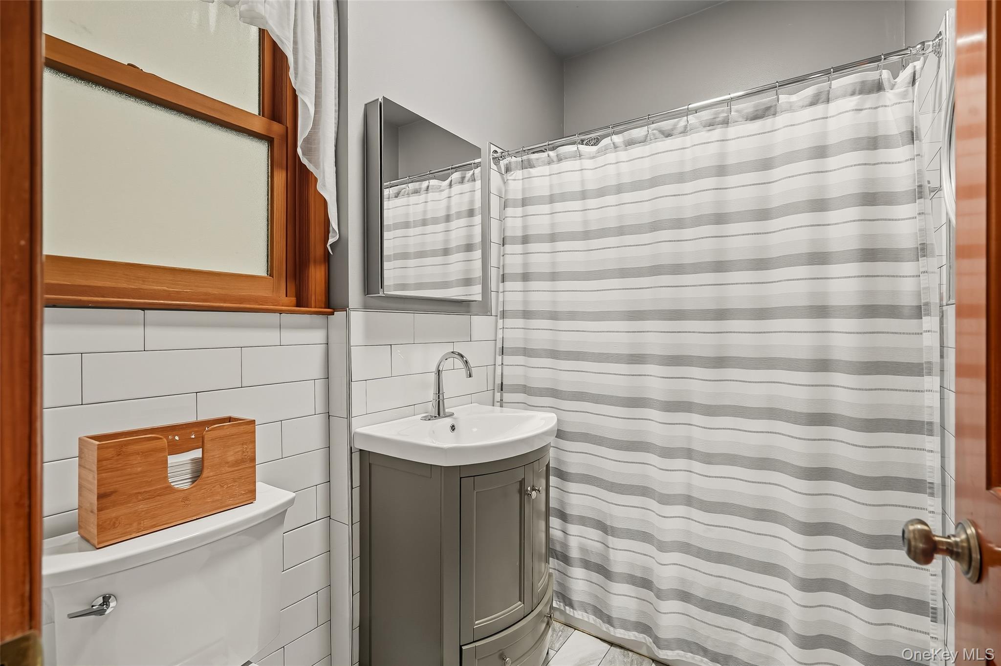 1444 Gillespie Avenue Bronx, NY 10461 - Photo 14 of 49 a bathroom with a sink and a mirror