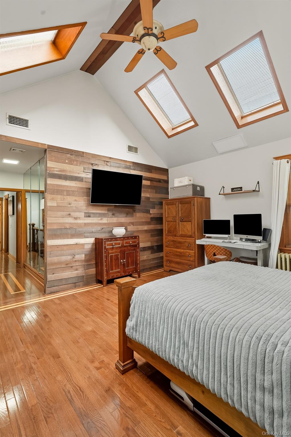 1444 Gillespie Avenue Bronx, NY 10461 - Photo 20 of 49 a bedroom with a bed a flat screen tv and chandelier