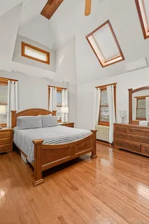 a bedroom with a bed and a night stand