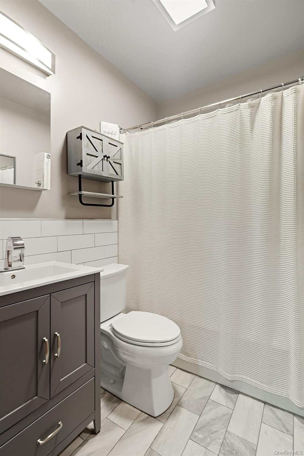 1444 Gillespie Avenue Bronx, NY 10461 - Photo 26 of 49 a bathroom with a toilet a sink and curtain