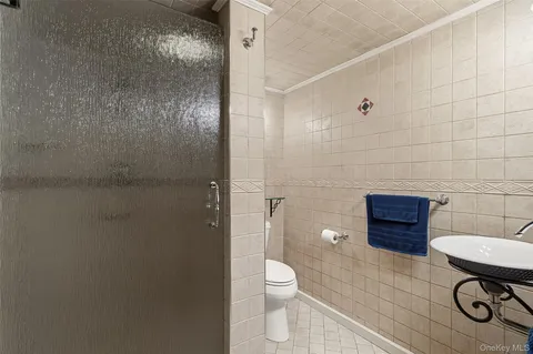 a bathroom with a toilet a sink and mirror