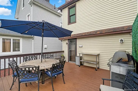 a view of a patio with a table and chairs under an umbrella