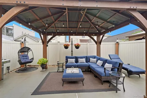a living room with furniture a rug and a window
