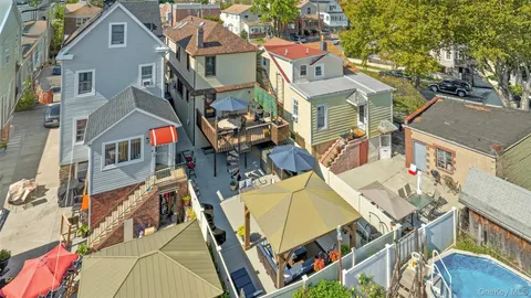 an aerial view of residential houses with outdoor space and street view