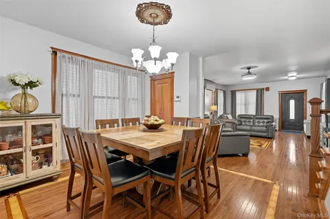a view of a dining room with furniture wooden floor and chandelier