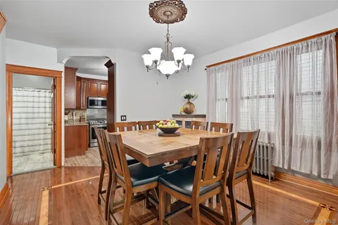 a view of a dining room with furniture wooden floor and chandelier