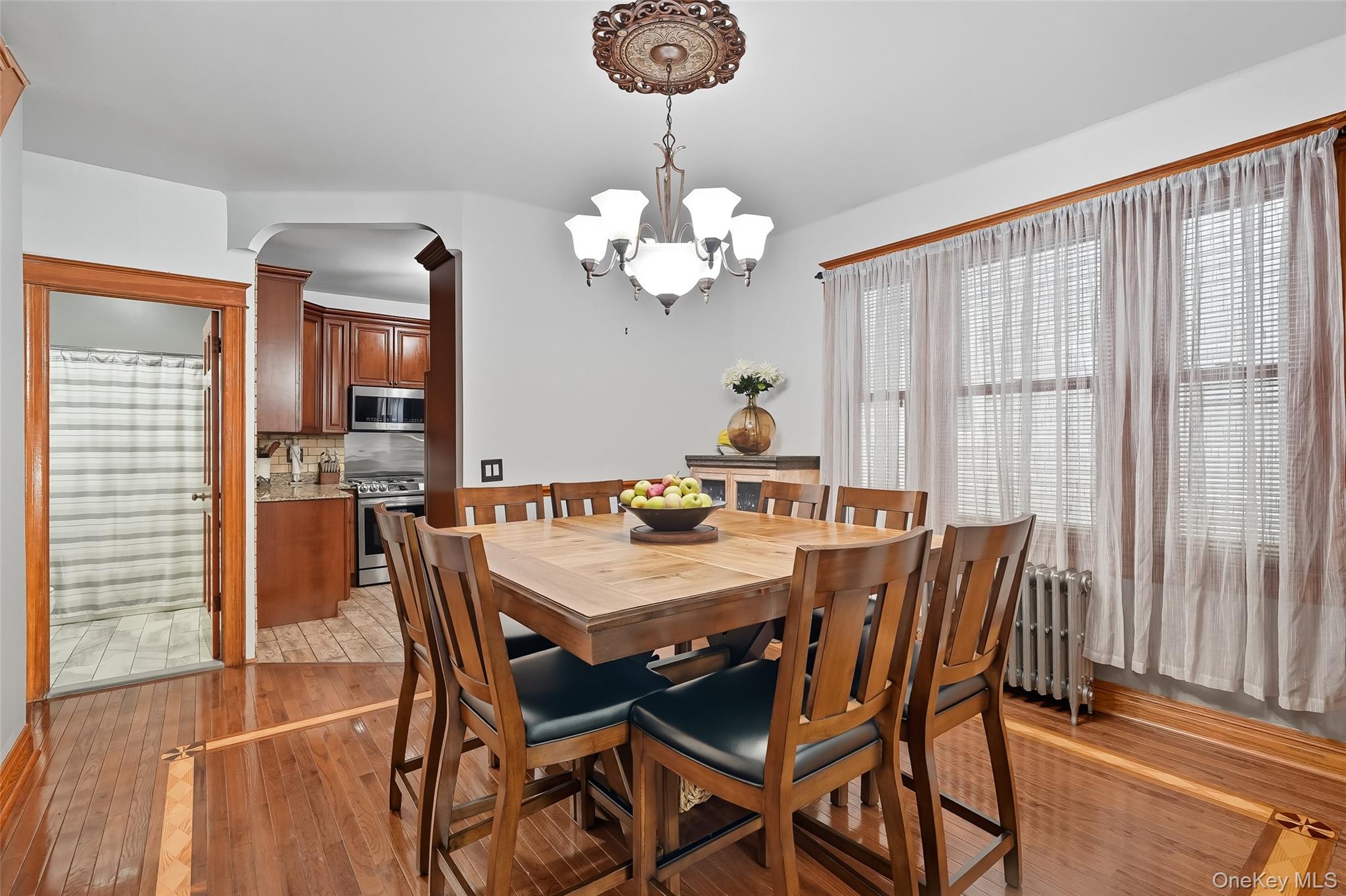 1444 Gillespie Avenue Bronx, NY 10461 - Photo 9 of 49 a view of a dining room with furniture wooden floor and chandelier