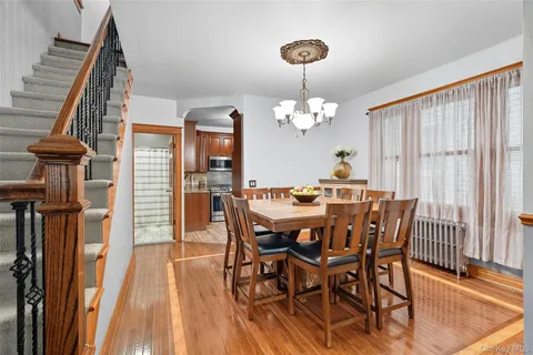 a view of a dining room with furniture wooden floor and chandelier