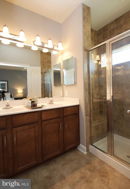 2144 Little Sorrel Way Silver Spring, MD 20902 - Photo 17 of 31 a bathroom with a double vanity sink mirror and shower