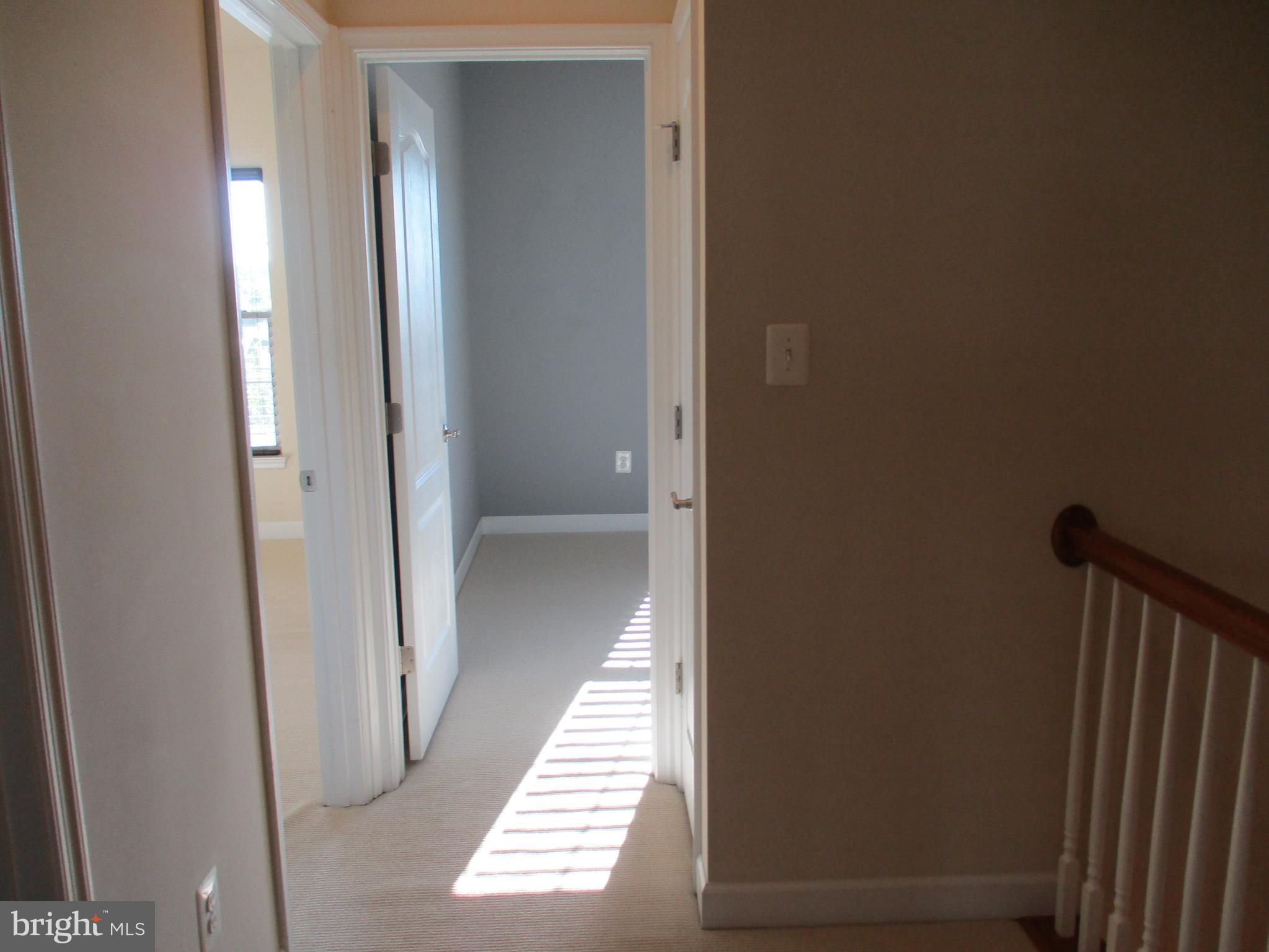 2144 Little Sorrel Way Silver Spring, MD 20902 - Photo 23 of 31 a view of a hallway with wooden floor and staircase