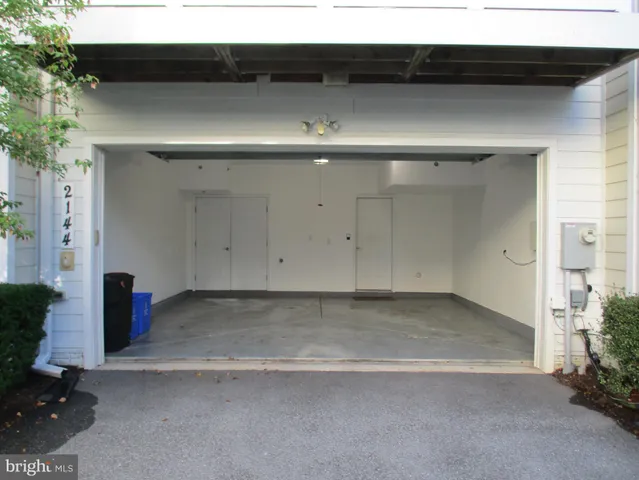 a kitchen with kitchen island granite countertop wooden cabinets a refrigerator and a sink