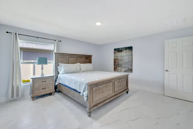 a bedroom with a bed and dresser