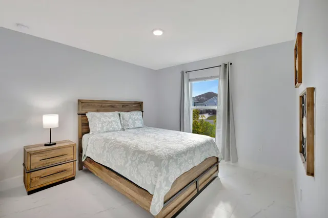 a bedroom with a bed and a window