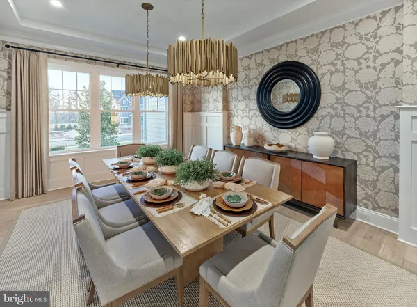 a dining room with furniture a rug and a large window