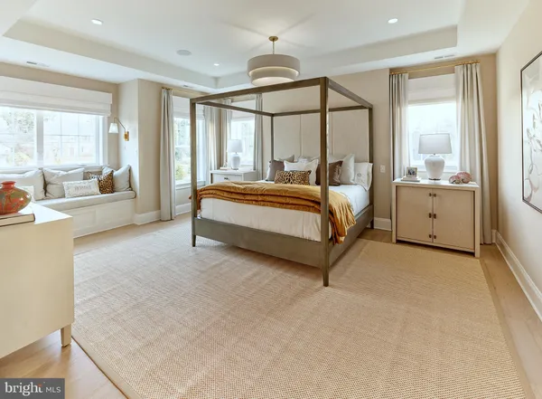a spacious bedroom with a large bed and a chandelier