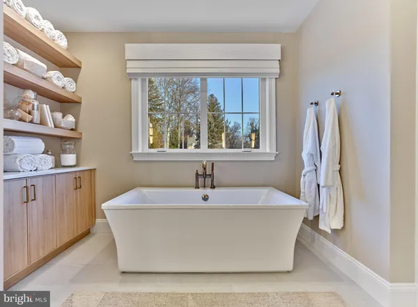 a white bath tub sitting next to a window