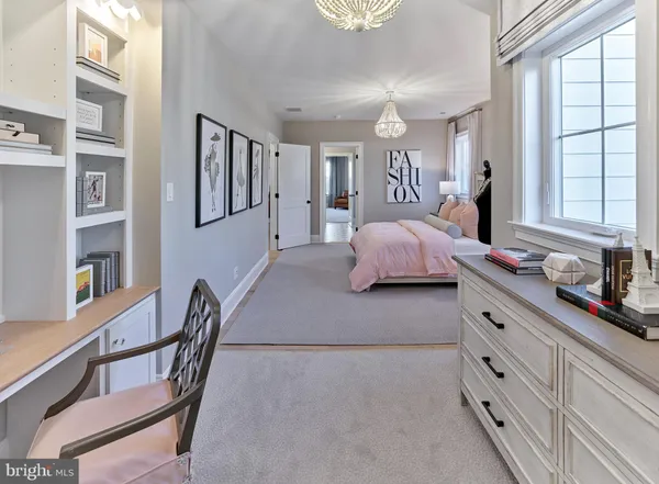 a spacious bedroom with a bed next to a large window with the dresser