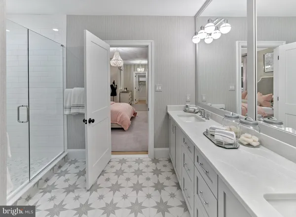 a spacious bathroom with a double vanity sink mirror and shower