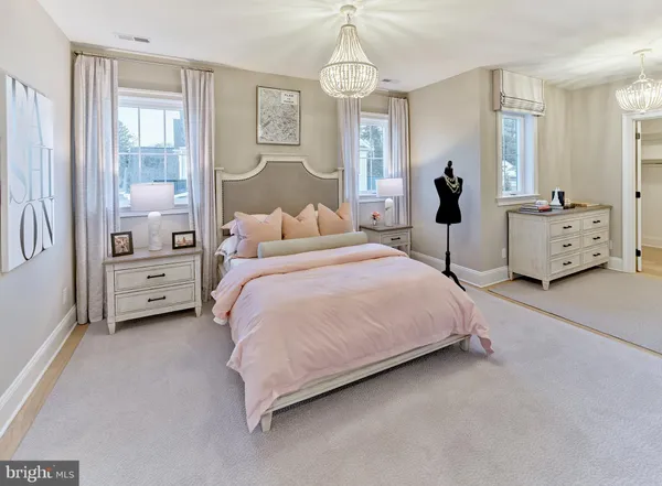 a spacious bedroom with a bed and a window