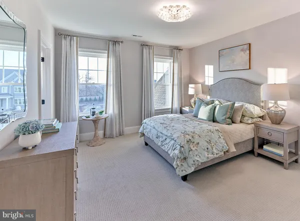 a bedroom with a bed and large window