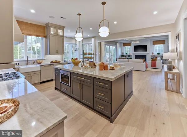 a large kitchen with stainless steel appliances granite countertop a lot of counter space and wooden floor