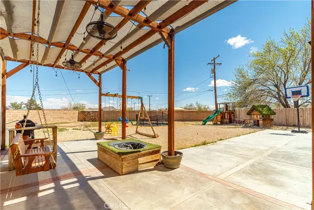 a view of a patio with a table and chairs
