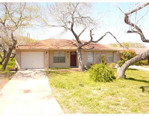 a front view of a house with a garden and patio