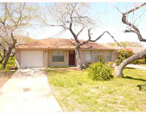 a front view of a house with a garden and patio