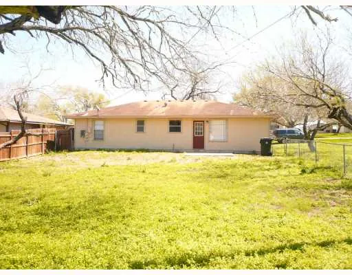 a front view of house with yard and swimming pool
