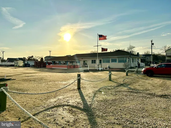 a view of swimming pool with outdoor seating and buildings in the background