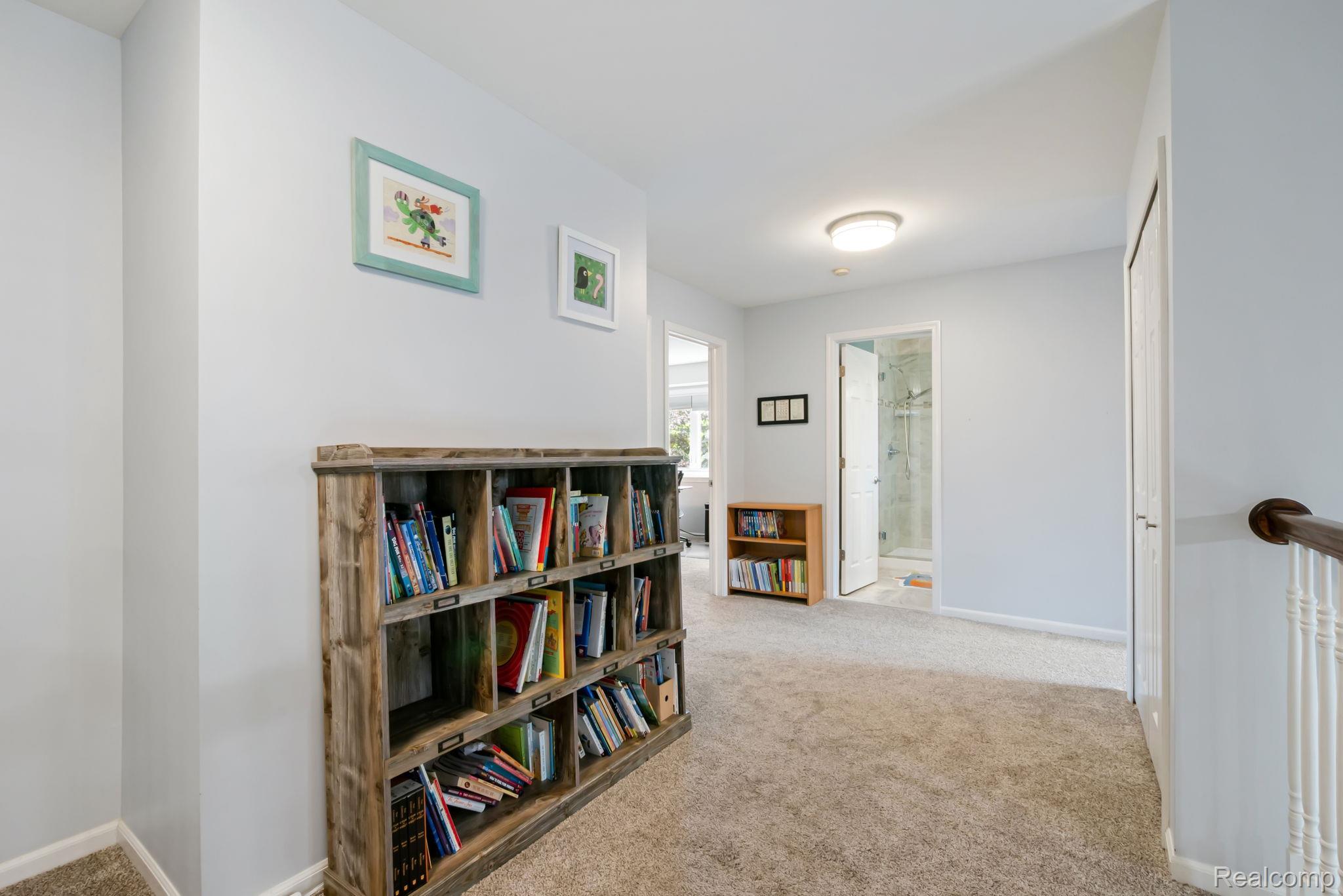1902 Grayslake Drive Rochester, MI 48306 - Photo 37 of 76 Upper-level hallway with neutral carpeting, light blue wall paint, and overhead flush mount lighting