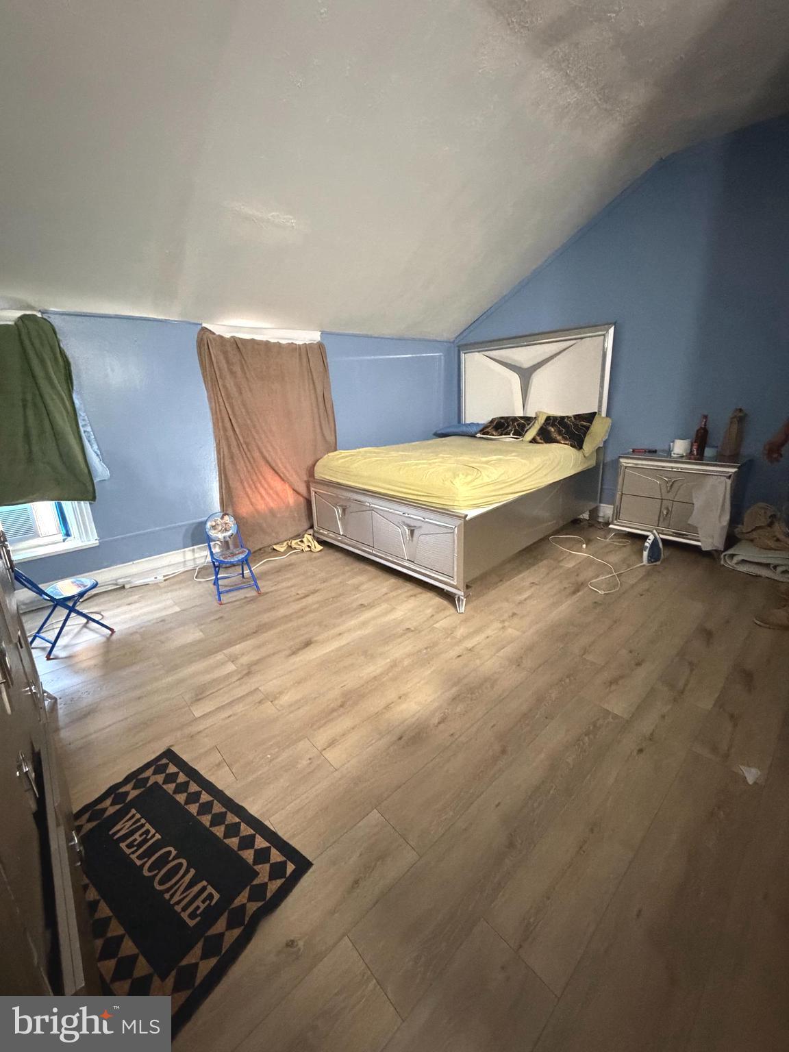 324 Spring Garden Street Reading, PA 19602 - Photo 14 of 20 a spacious bedroom with a bed and a night stand