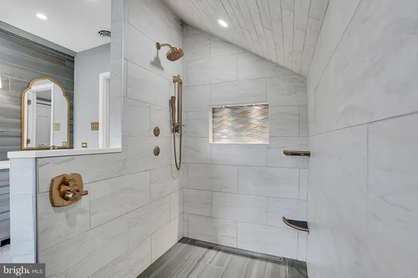 a spacious bathroom with a double vanity sink and a mirror