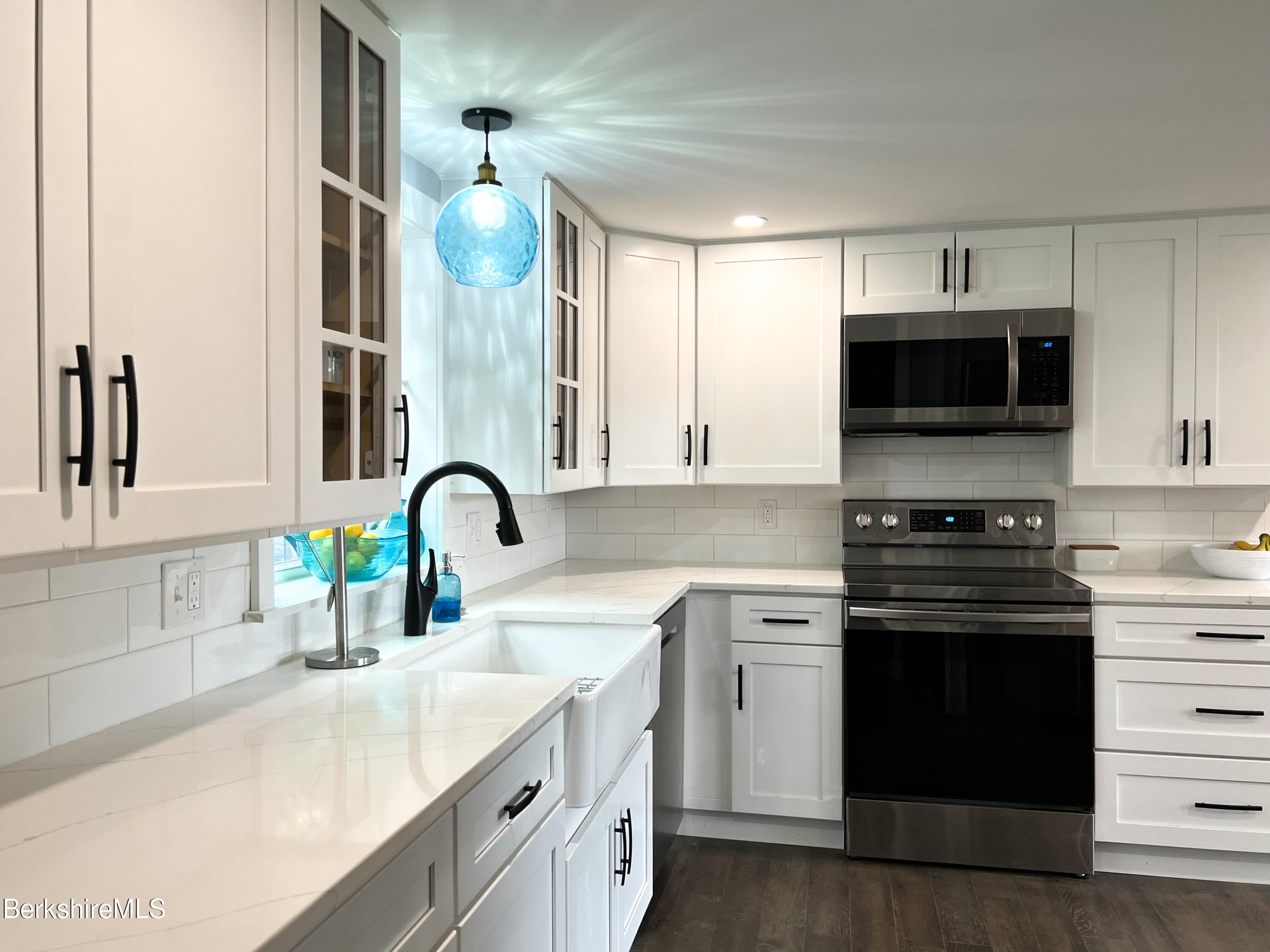 910 Daniels Road Clarksburg, MA 01247 - Photo 15 of 41 a kitchen with stainless steel appliances granite countertop a sink and a stove