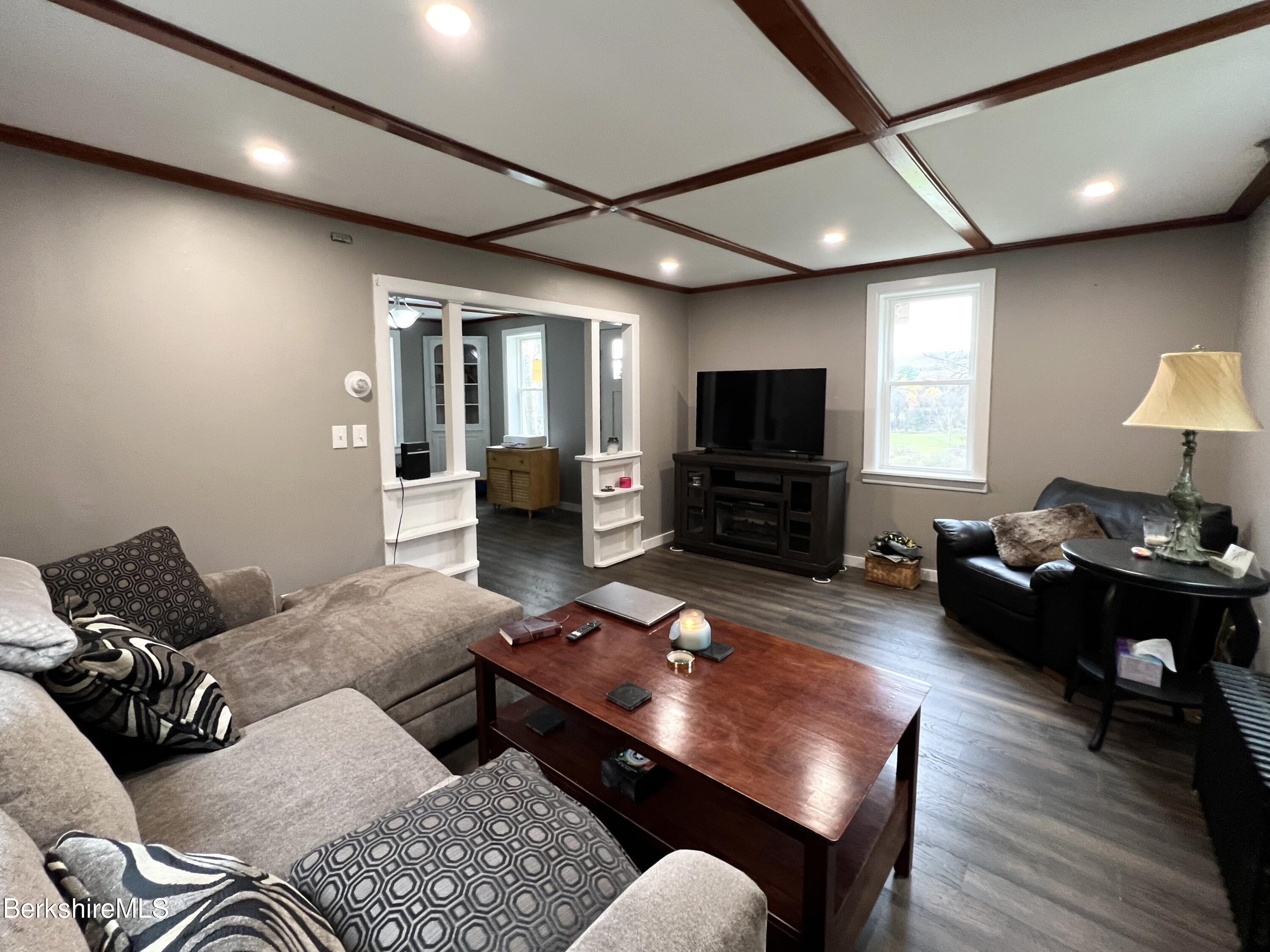 910 Daniels Road Clarksburg, MA 01247 - Photo 24 of 41 a living room with furniture and a flat screen tv