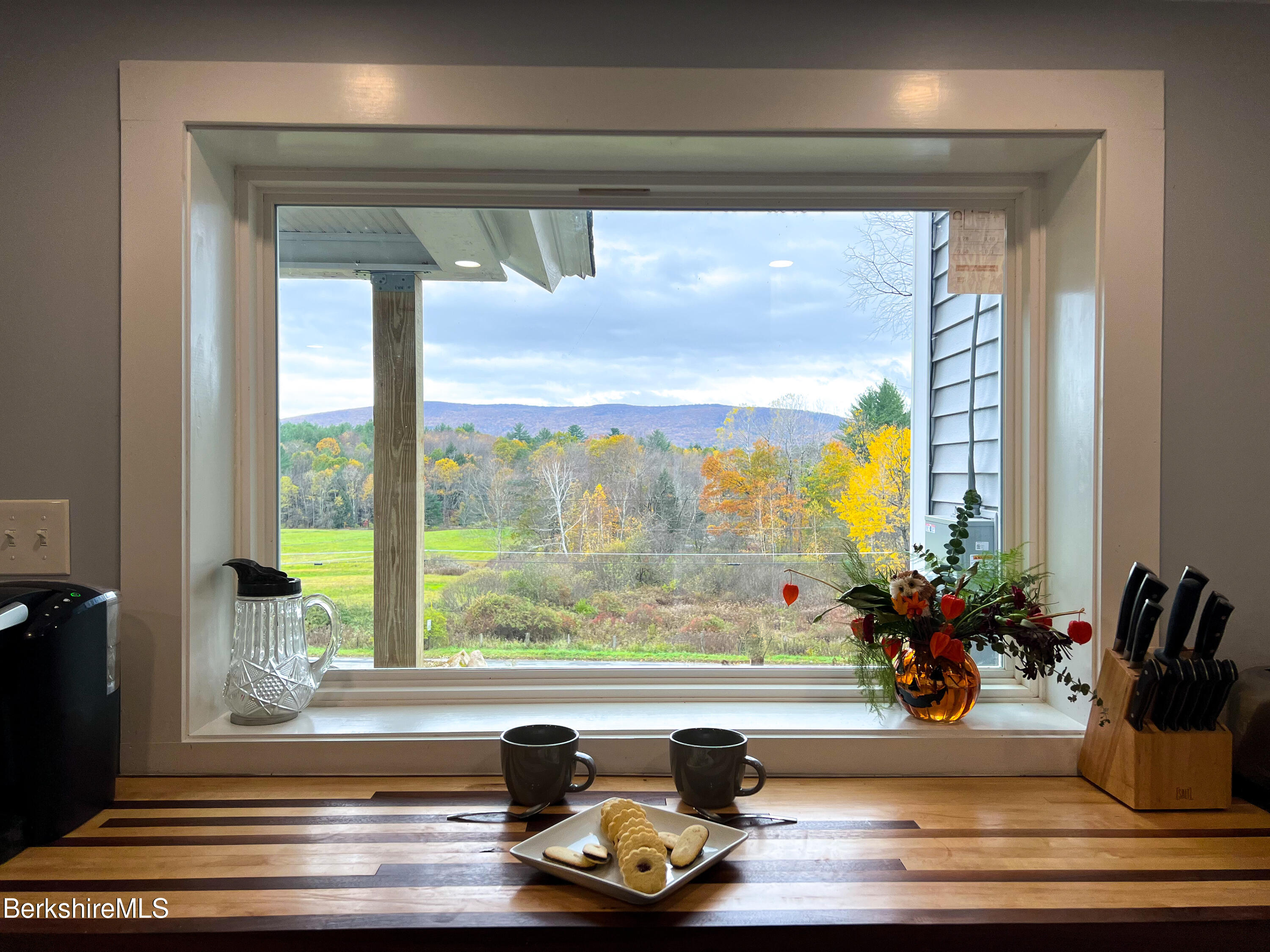 910 Daniels Road Clarksburg, MA 01247 - Photo 4 of 41 a view of a living room with a floor to ceiling window and wooden floor