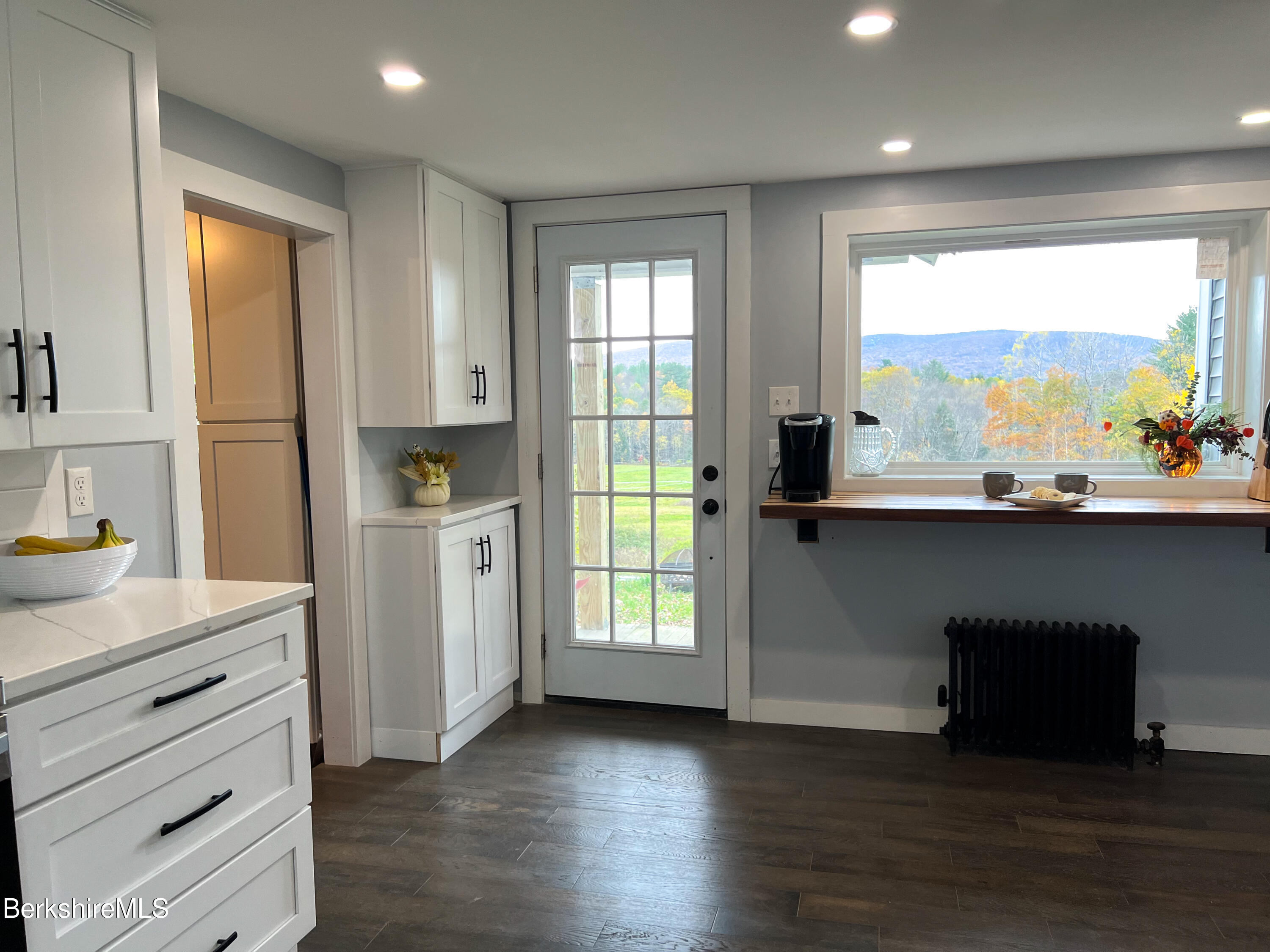 910 Daniels Road Clarksburg, MA 01247 - Photo 6 of 41 a kitchen with a sink window and cabinets