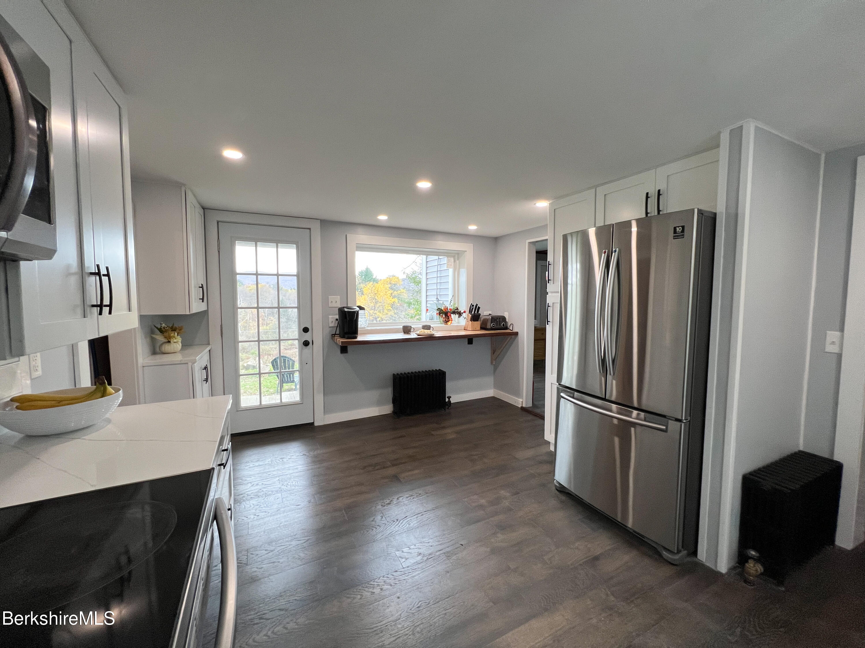910 Daniels Road Clarksburg, MA 01247 - Photo 8 of 41 a kitchen with a refrigerator and a sink