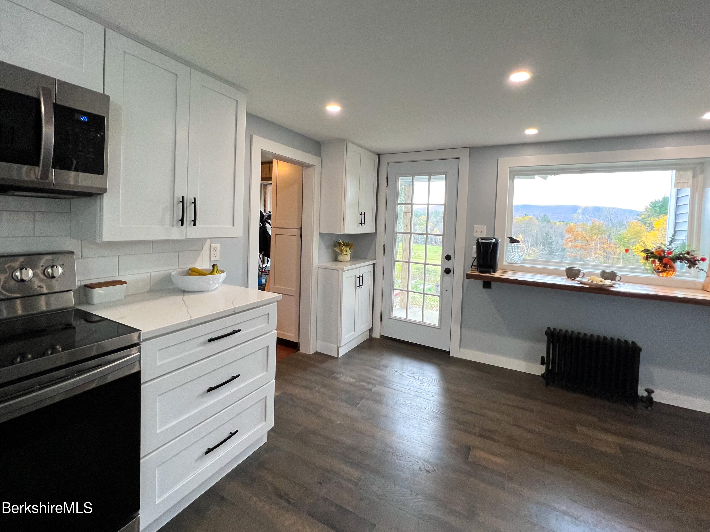 910 Daniels Road Clarksburg, MA 01247 - Photo 9 of 41 a kitchen with stainless steel appliances a stove sink and cabinets
