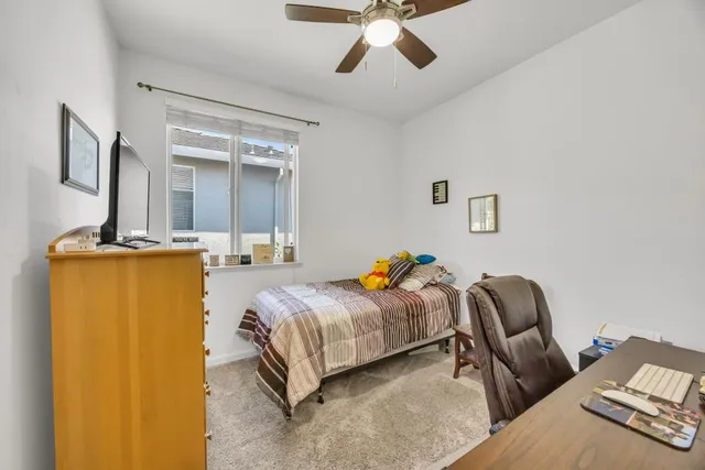 a room with a sink bed and a large window