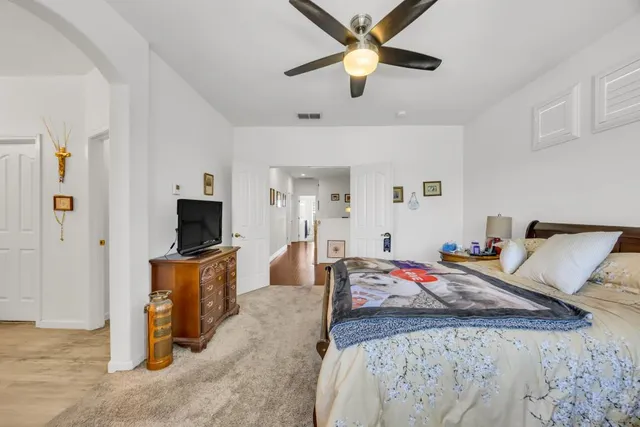 a en suite bathroom with a granite countertop sink and a mirror