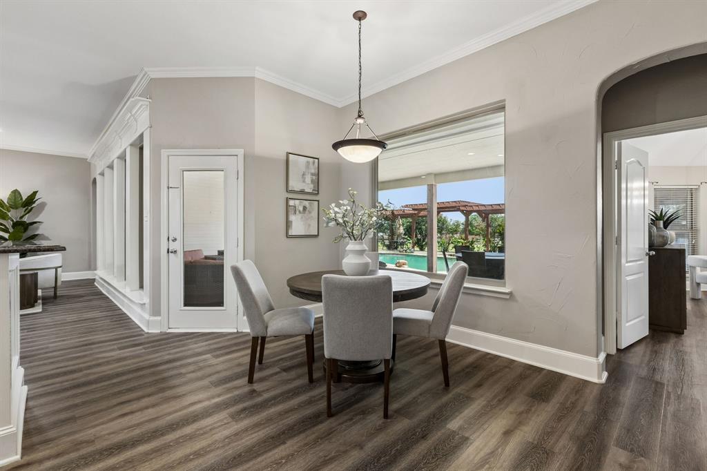 317 Singing Quail Trail Haslet, TX 76052 - Photo 11 of 32 Dining area with wood-finish flooring and a contemporary pendant light fixture