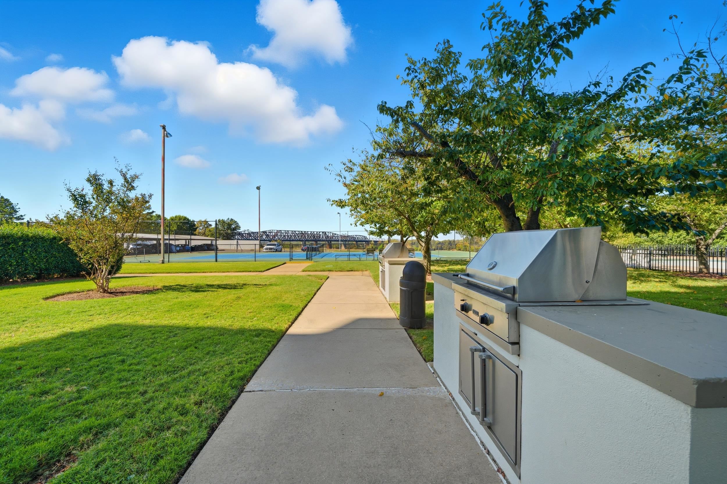 655 Riverside Drive, Unit 205A Memphis, TN 38103 - Photo 13 of 24 a view of a swimming pool with a yard and plants