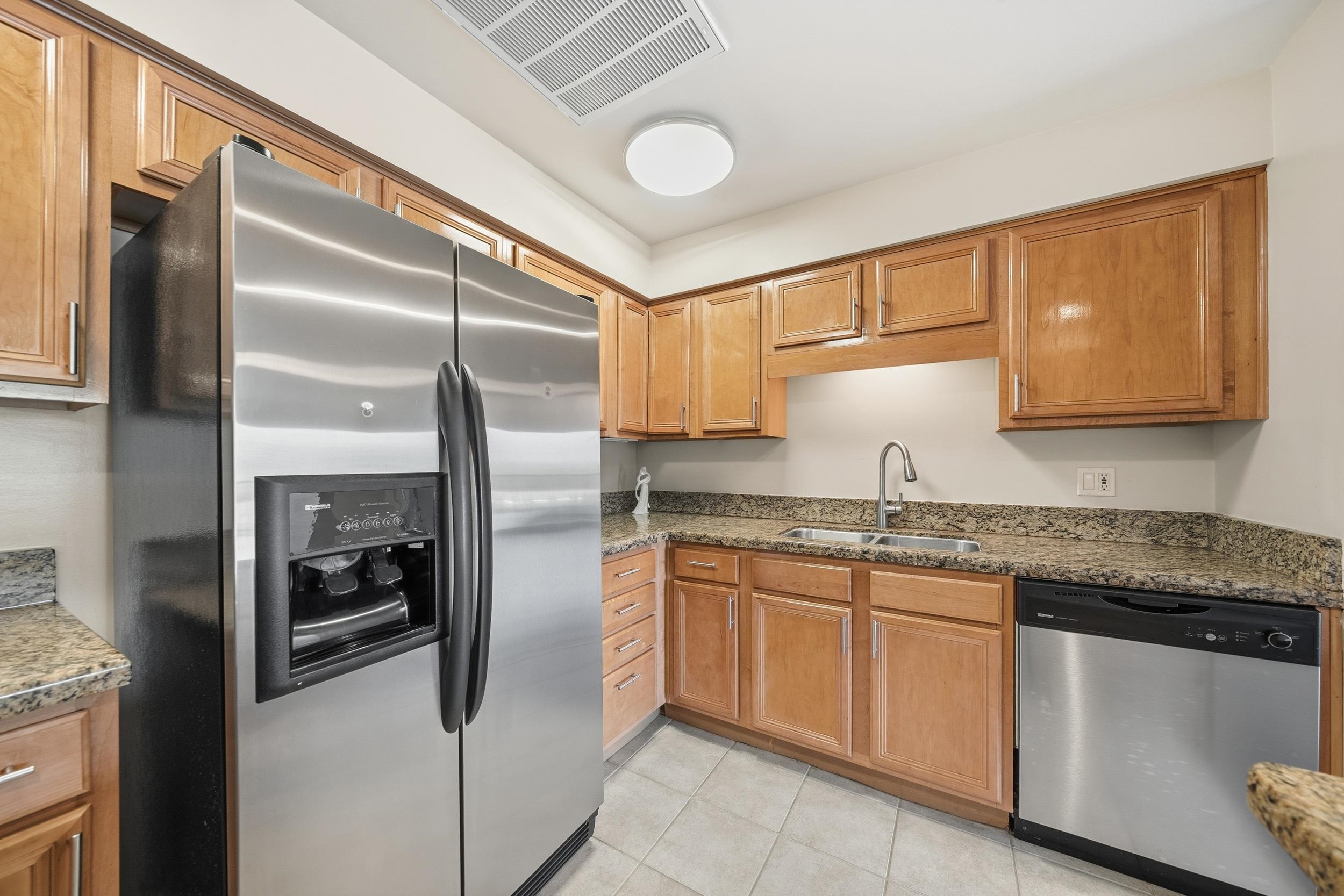 655 Riverside Drive, Unit 205A Memphis, TN 38103 - Photo 4 of 24 a kitchen with stainless steel appliances granite countertop a refrigerator and a sink