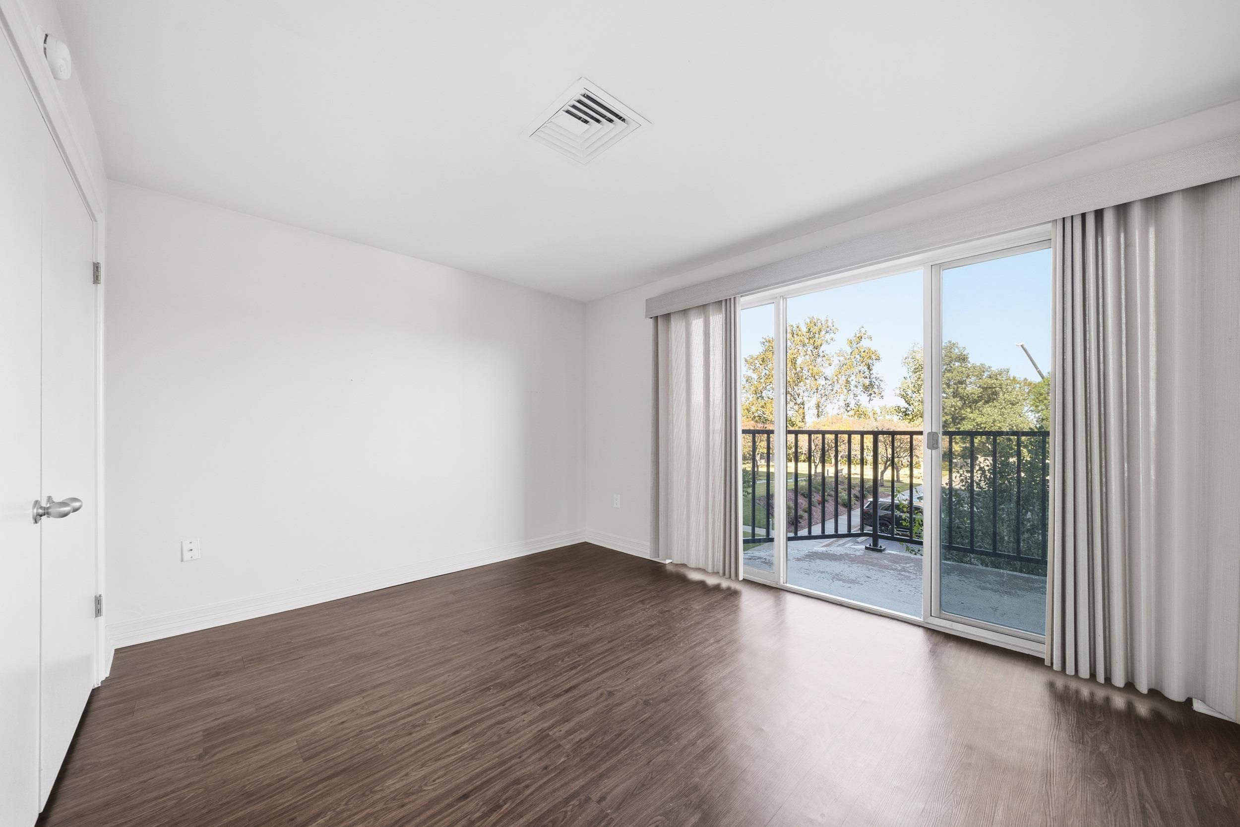 655 Riverside Drive, Unit 205A Memphis, TN 38103 - Photo 7 of 24 wooden floor in an empty room with a window