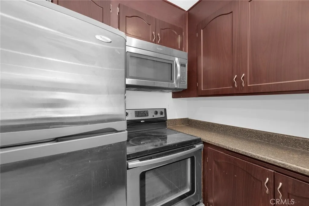 7890 East Spring Street, Unit 4A Long Beach, CA 90815 - Photo 12 of 21 a kitchen with a stove and a microwave