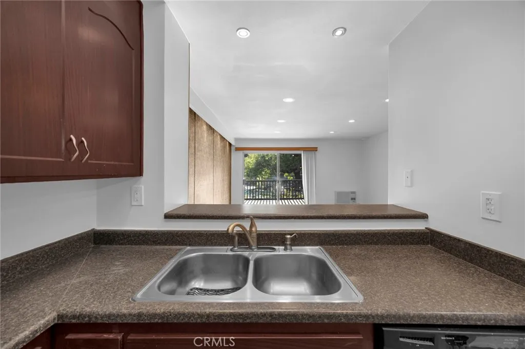 7890 East Spring Street, Unit 4A Long Beach, CA 90815 - Photo 13 of 21 a kitchen with a sink and a window