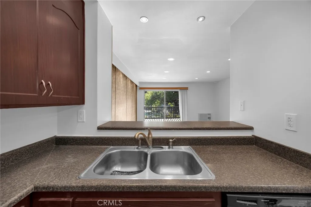 7890 East Spring Street, Unit 4A Long Beach, CA 90815 - Photo 13 of 21 a kitchen with a sink and a window